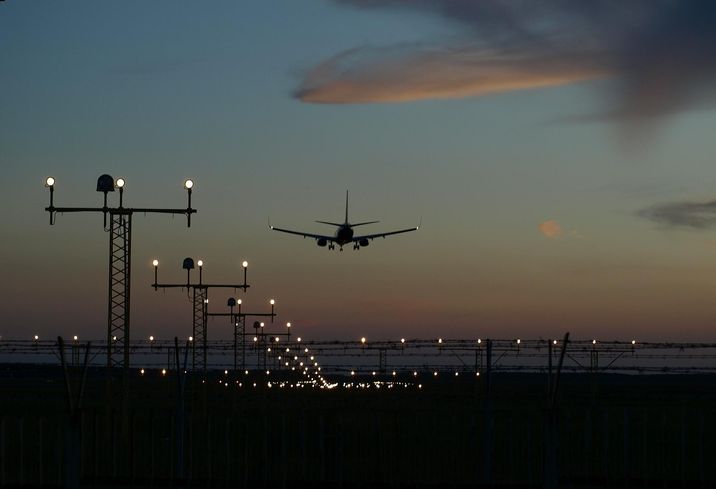 Airplane landing at dusk